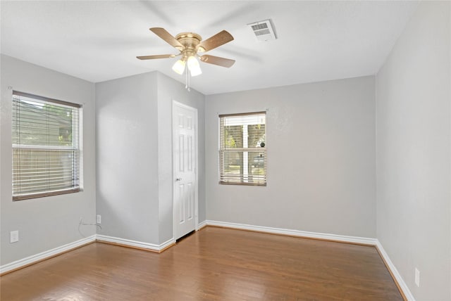 empty room featuring hardwood / wood-style flooring and ceiling fan