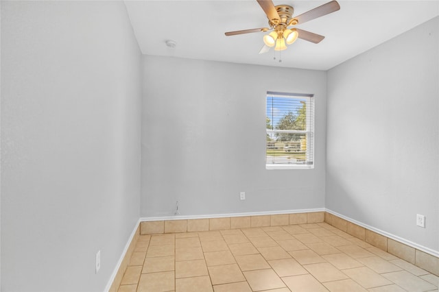 empty room with light tile patterned floors and ceiling fan