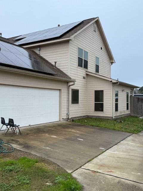 7 N Pine Rd, Texas City, TX 77591 - view of front facade with concrete driveway, solar panels, and an attached garage