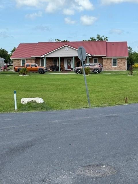 7 N Pine Rd, Texas City, TX 77591 - ranch-style house with metal roof and a front yard