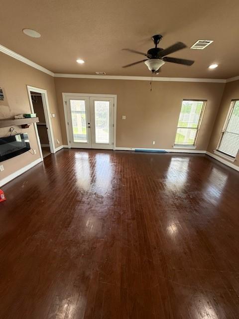7 N Pine Rd, Texas City, TX 77591 - unfurnished living room with ornamental molding, dark wood-style flooring, a ceiling fan, baseboards, and french doors