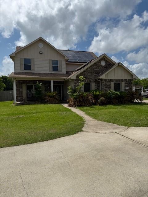 7 N Pine Rd, Texas City, TX 77591 - craftsman-style house featuring roof mounted solar panels, board and batten siding, and stone siding