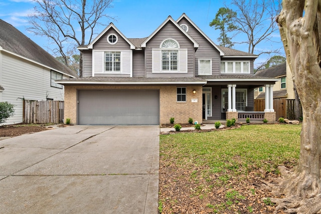 view of front facade with a garage, covered porch, and a front lawn