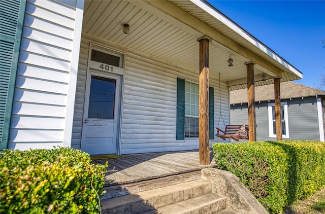 view of exterior entry with a porch