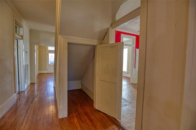 hallway with ornamental molding and dark hardwood / wood-style flooring