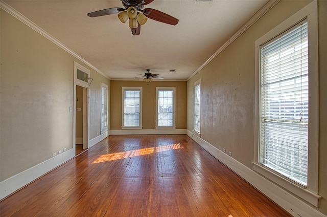 spare room with hardwood / wood-style floors, crown molding, and ceiling fan