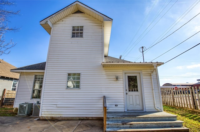 back of property featuring central AC