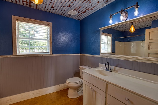 bathroom with walk in shower, vanity, toilet, and wood walls