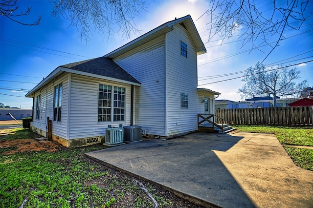 rear view of house featuring cooling unit and a patio