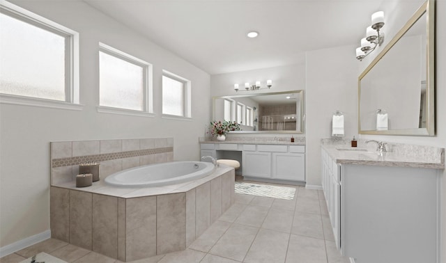 bathroom with vanity, tile patterned floors, and tiled bath