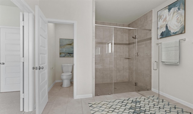 bathroom featuring tile patterned floors, toilet, and walk in shower