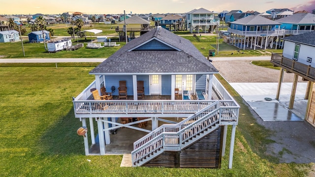 back of property featuring roof with shingles, stairway, a deck, a balcony, and a residential view