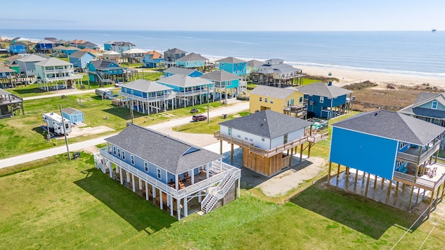 bird's eye view with a residential view, a water view, and a beach view