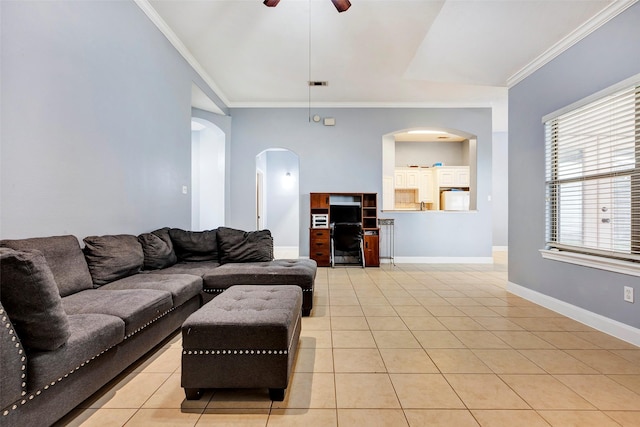 living room with light tile patterned flooring, ornamental molding, and ceiling fan