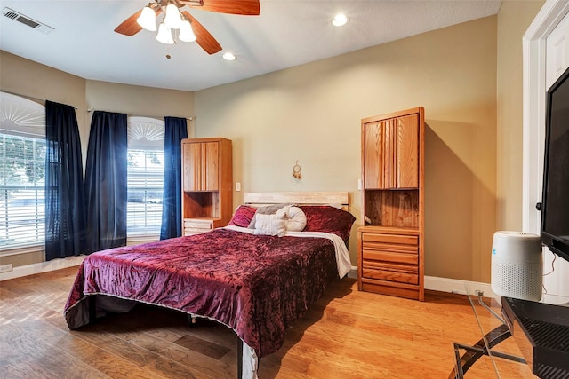 bedroom with ceiling fan and light wood-type flooring