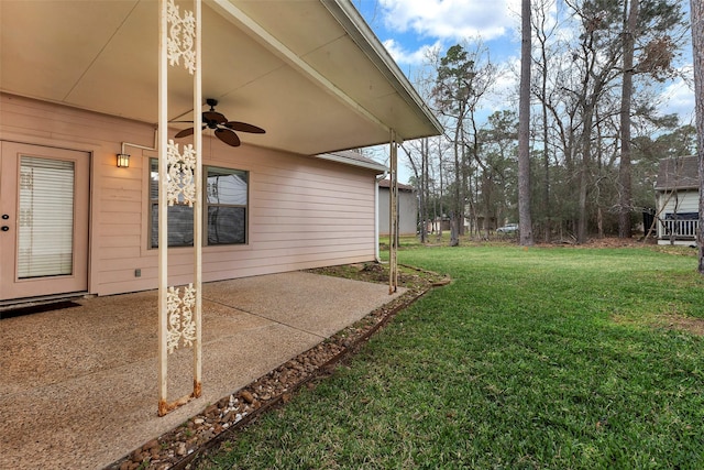 view of yard with ceiling fan and a patio area