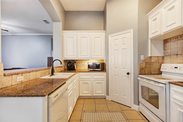 kitchen with light tile patterned flooring, sink, white cabinets, kitchen peninsula, and white appliances