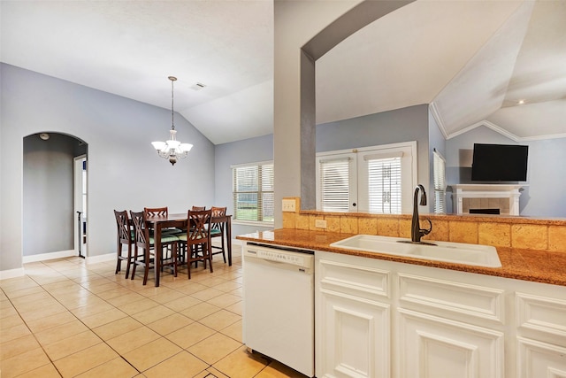 kitchen featuring light tile patterned flooring, pendant lighting, lofted ceiling, sink, and white dishwasher