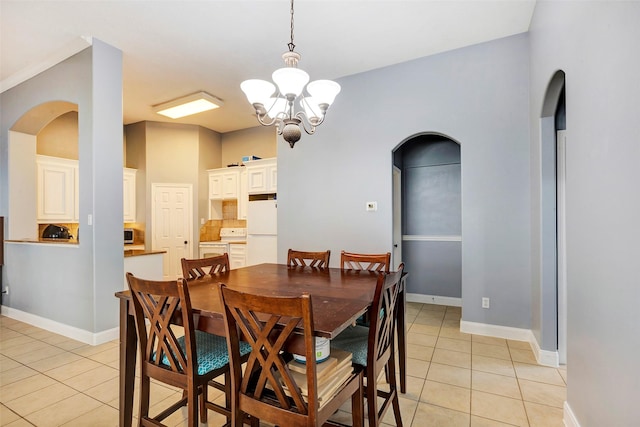 dining room featuring light tile patterned flooring and a notable chandelier