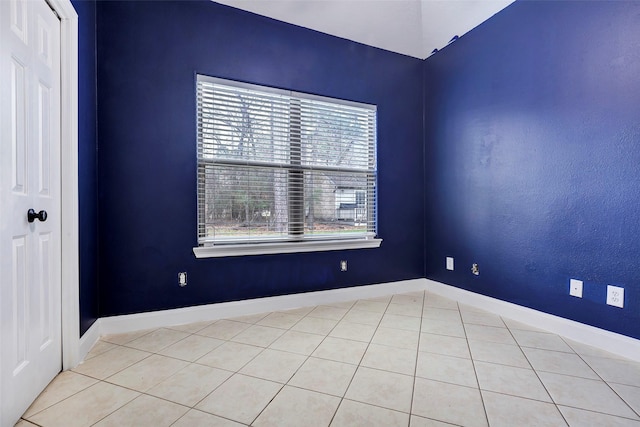 empty room with light tile patterned flooring