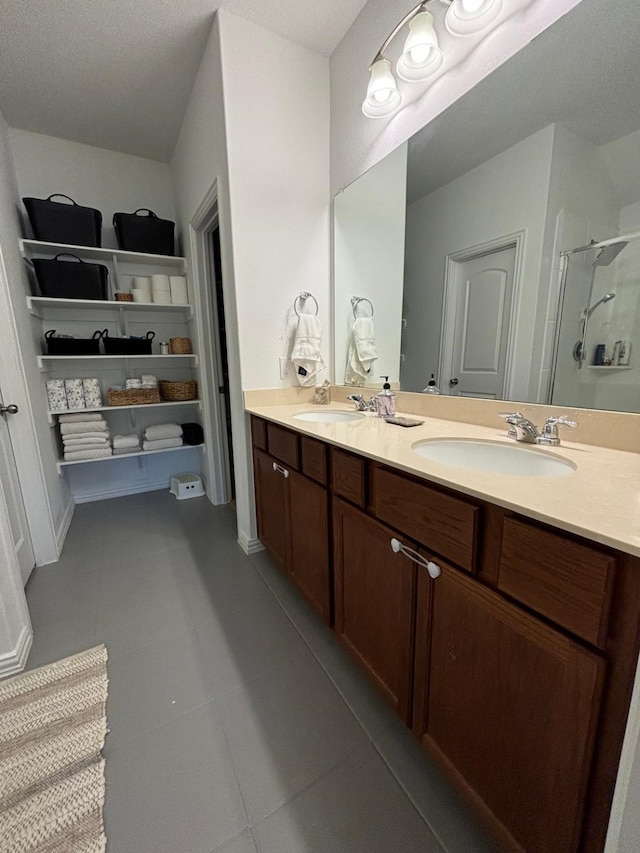 bathroom with vanity, tile patterned flooring, and a shower with door