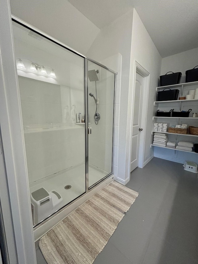 bathroom with a shower with door