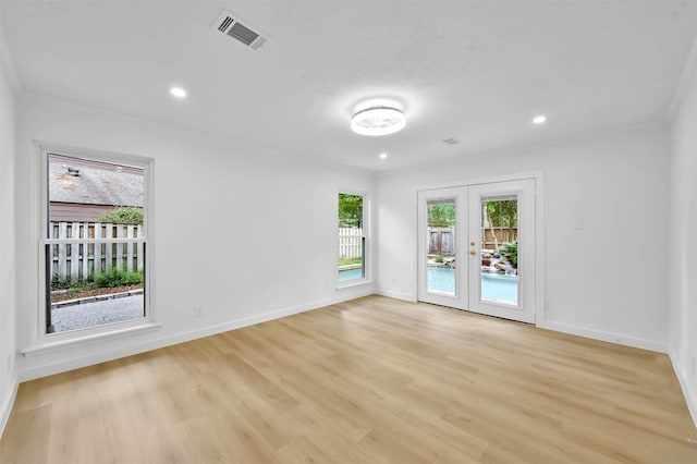 unfurnished room with french doors and light hardwood / wood-style floors