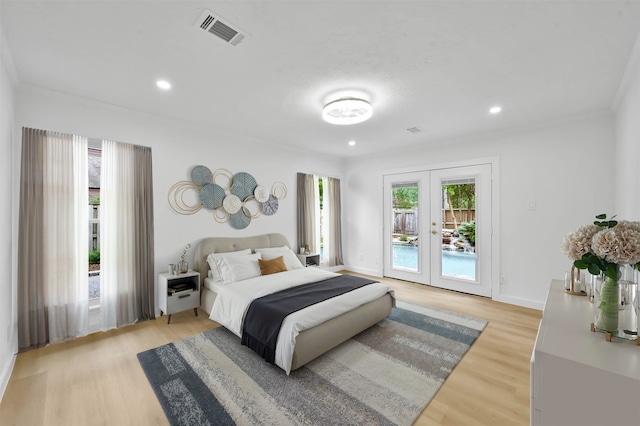 bedroom featuring access to exterior, french doors, and light wood-type flooring