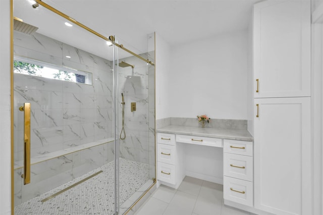 bathroom with a shower with door and tile patterned floors