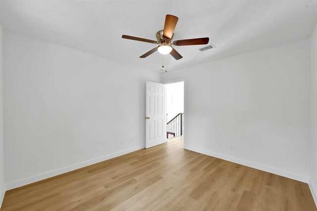 empty room with light hardwood / wood-style flooring and ceiling fan