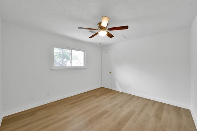 empty room featuring ceiling fan and light wood-type flooring