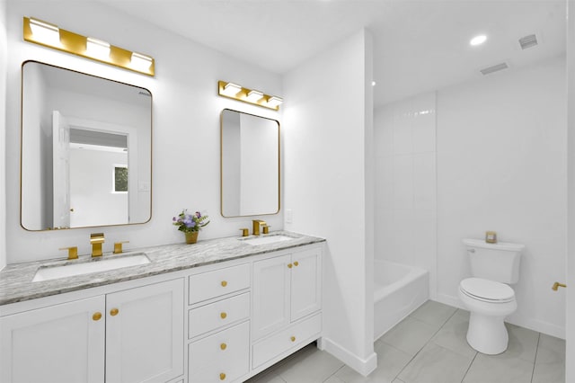 bathroom featuring vanity, tile patterned flooring, and toilet