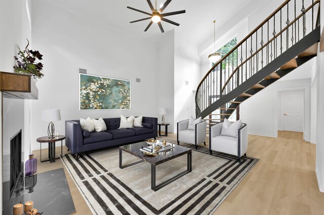 living room with a high ceiling and light wood-type flooring