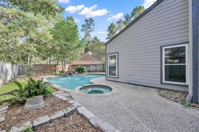 view of swimming pool featuring an in ground hot tub