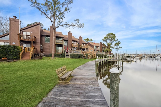 view of dock featuring a water view and a lawn