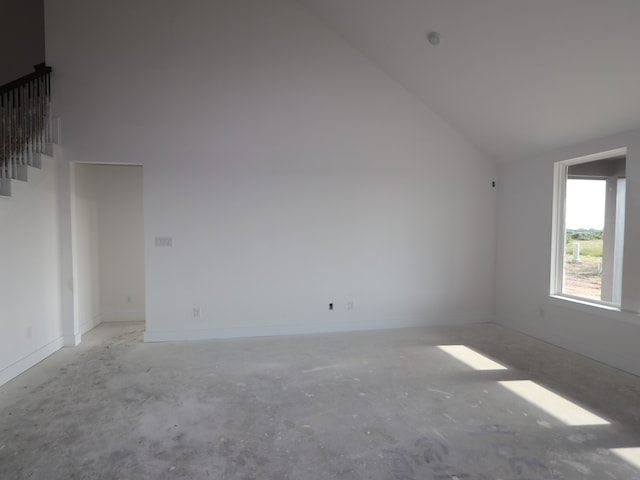 8315 Oceanmist Cove Dr, Cypress, TX 77433 - additional living space with high vaulted ceiling, unfinished concrete floors, baseboards, and stairway