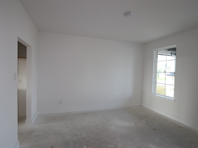 8315 Oceanmist Cove Dr, Cypress, TX 77433 - empty room featuring unfinished concrete flooring and baseboards
