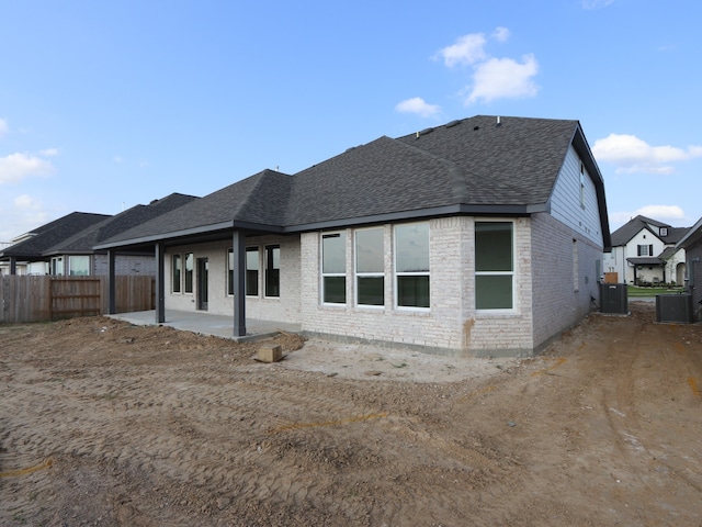 8315 Oceanmist Cove Dr, Cypress, TX 77433 - back of house with roof with shingles, brick siding, a patio area, and central AC
