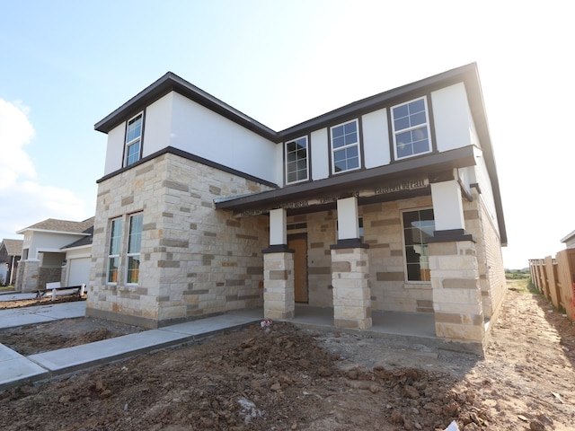 8315 Oceanmist Cove Dr, Cypress, TX 77433 - view of front of home with stone siding, a porch, and stucco siding