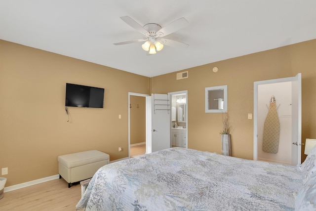 bedroom with visible vents, baseboards, a ceiling fan, light wood-style flooring, and a sink