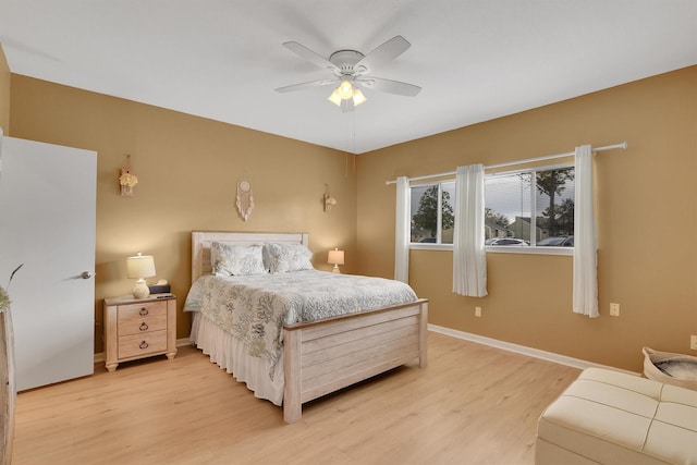 bedroom with a ceiling fan, baseboards, and wood finished floors