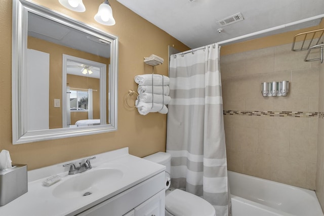 bathroom with visible vents, vanity, toilet, and shower / bath combo with shower curtain