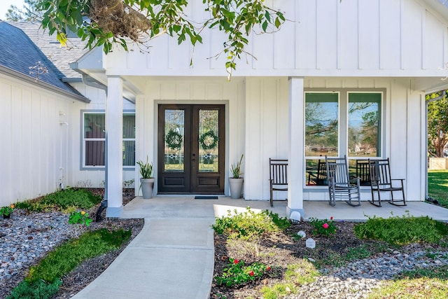 property entrance featuring covered porch and french doors