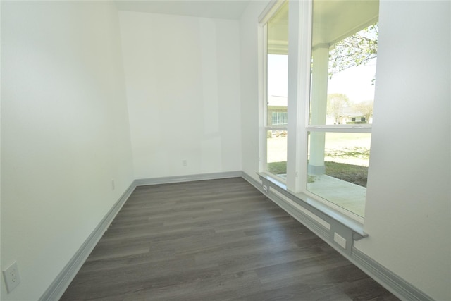 29 Westwood Dr W, Trinity, TX 75862 - empty room featuring plenty of natural light, baseboards, and dark wood-style flooring