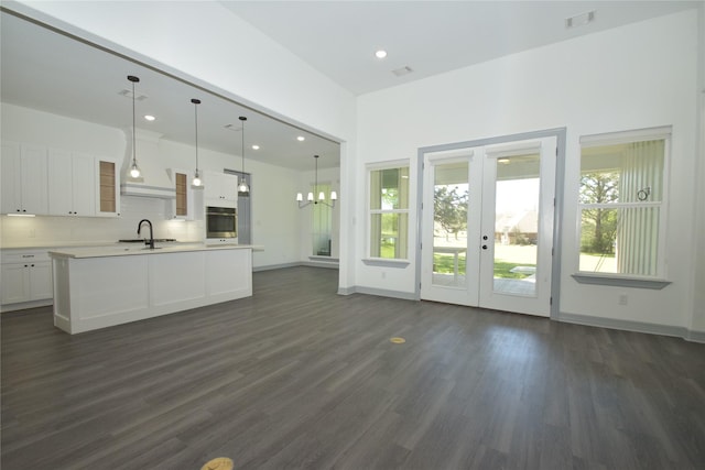 29 Westwood Dr W, Trinity, TX 75862 - unfurnished living room featuring a sink, dark wood-style flooring, a chandelier, french doors, and recessed lighting