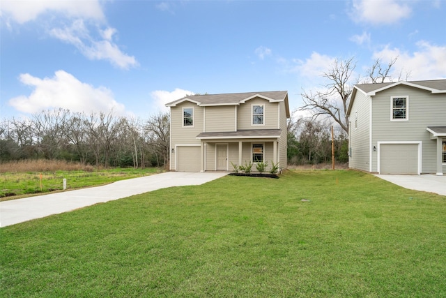 view of property with a garage and a front lawn