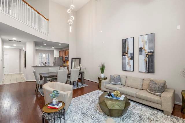 living room featuring a high ceiling and wood-type flooring