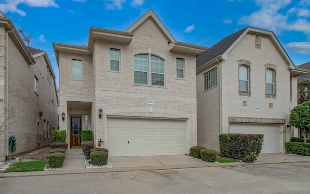 view of property with brick siding, concrete driveway, and a garage