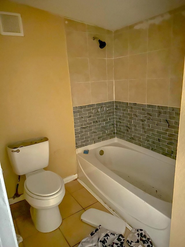 bathroom with tile patterned floors, shower with separate bathtub, and toilet