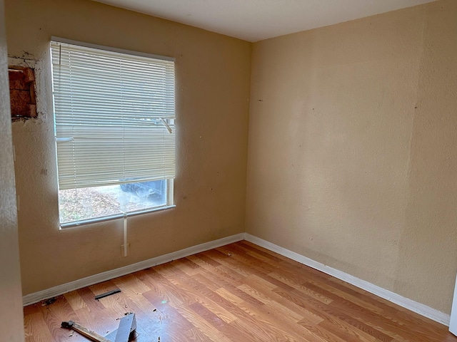 unfurnished room with light hardwood / wood-style floors